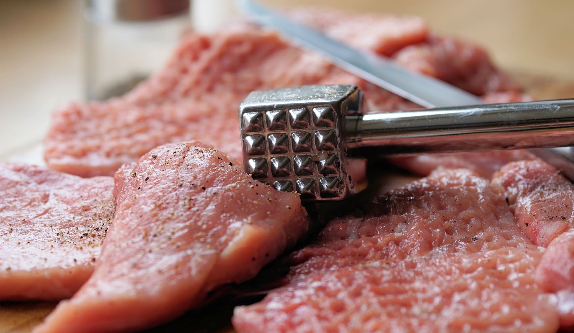 Beaten pork cutlets with meat hammer