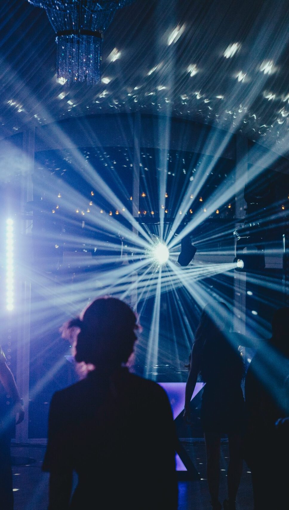 Guest in front of a light show at a party